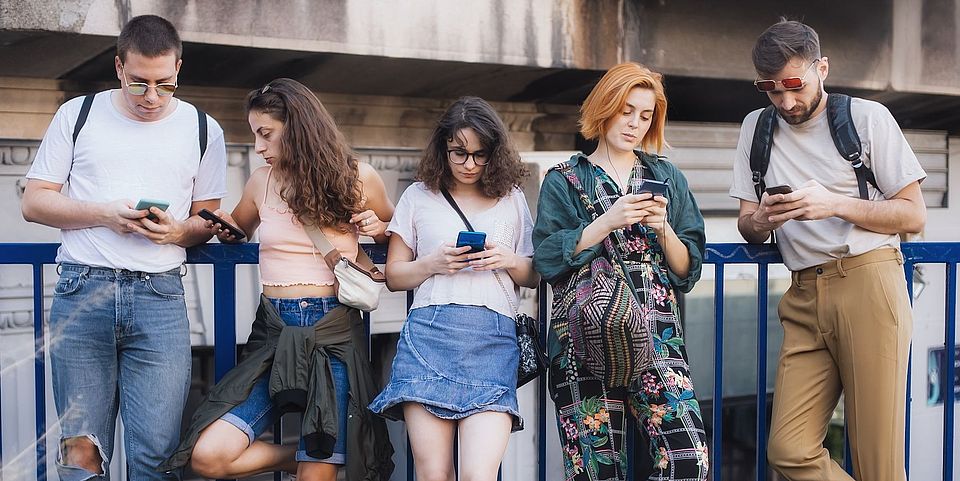 youths holding smartphones